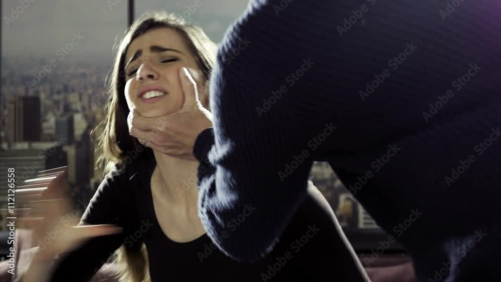 man pulling womans hair from behind