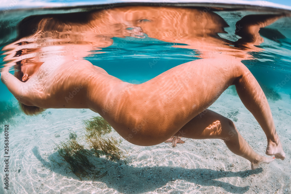 naked women swimming underwater